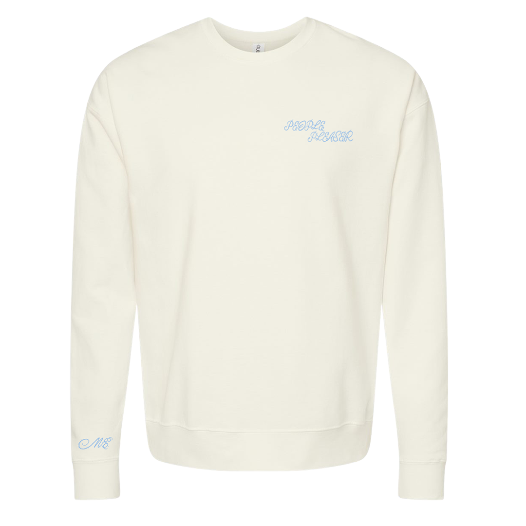 An off-white crewneck sweatshirt with light blue cursive text on the left chest reading 'PEOPLE PLEASER' and a matching light blue monogram on the left sleeve
